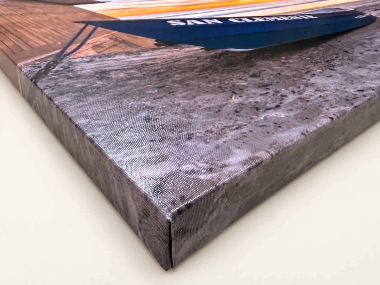 Corner of a hand-stretched gallery-wrapped canvas print with a crisp folded edge
